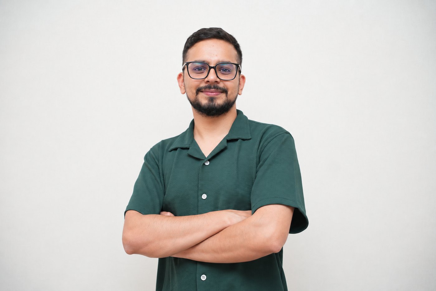 Laxman Pokhrel standing with his arms crossed, wearing a dark green shirt